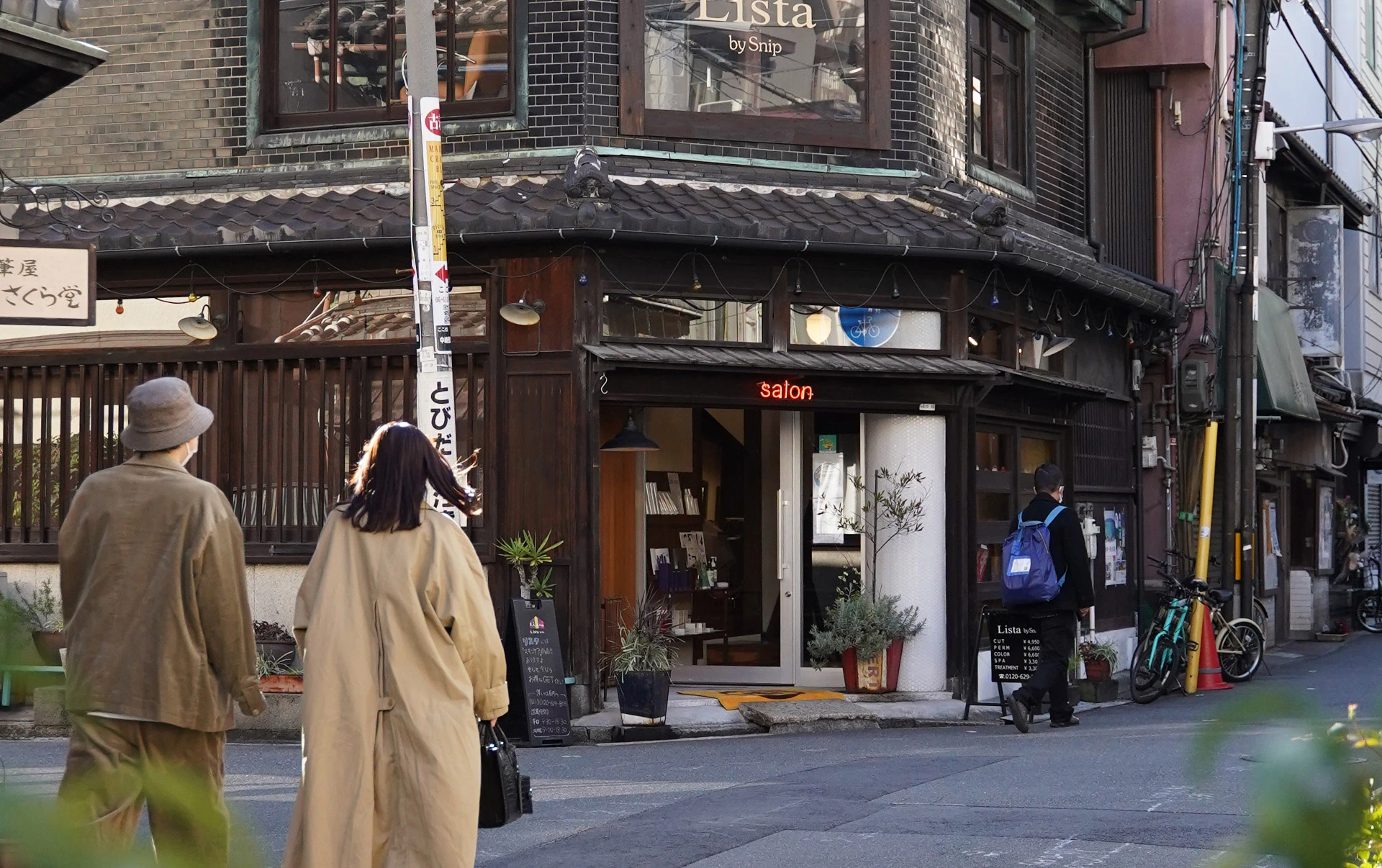 Old wooden corner shop on a quiet Nakazakicho street in Osaka, locals walking past — hidden neighborhood stop on a private Osaka tour